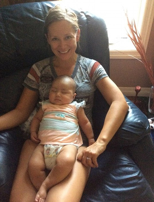 Baby Ayla sleeps happily in the arms of her aunt Nora in a new image of the incredible survivor. Photo / Facebook 
