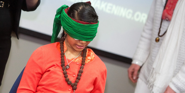 Ma Nithya Maheshwarananda, 12 reading while blinded by eye patches and two blindfolds PHOTO/BEN FRASER