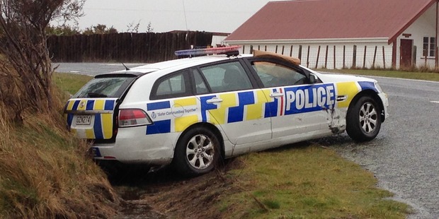 Police are guarding the scene of the recovered vehicle which has a prominent dent. Photo / Supplied