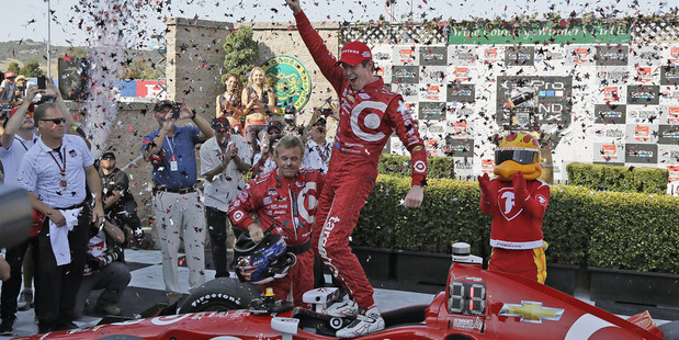 Scott Dixon celebrates atop his car after winning the IndyCar championship. Photo / AP
