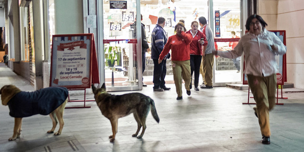 People leave a supermarket during a strong quake in Santiago. Photo / AFP