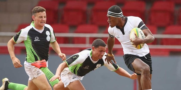 Loading Sefanaia Volau of Fiji breaks aay to score a try during the boys rugby sevens match between Fiji and Namibia. Photo / Getty Images.