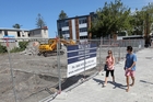 Diggers have begun clearing the demolition rubble at the Hastings St site which will become a temporary car park. Photo / Duncan Brown Diggers have begun clearing the demolition rubble at the Hastings St site which will become a temporary car park. Photo / Duncan Brown