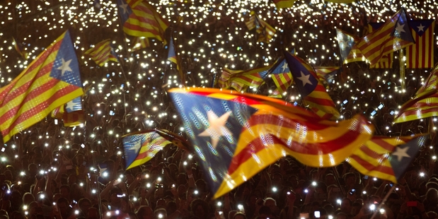 Pro-independence supporters wave Catalan separatist flags during a rally in Barcelona. Photo / AP