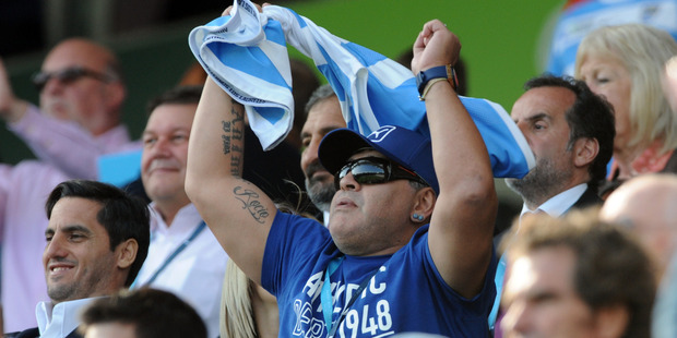 Argentine football great Diego Maradona cheers in the crowd. Photo / AP