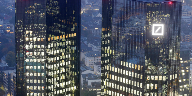 Deutsche Bank's Frankfurt headquarters. The global banking giant is shedding 35,000 staff and will shut its NZ operation. Photo / AP