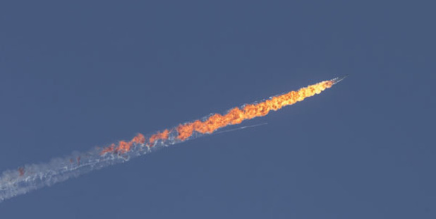 The warplane catches on fire after being shot. Photo / Getty Images