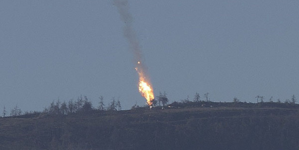 A Russian warplane goes down in Syria's northwestern Turkmen town of Bayirbucak near Turkeys border. Photo / Getty Images