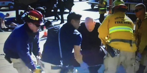 Emergency services attend to the wounded at the scene of the shooting. 