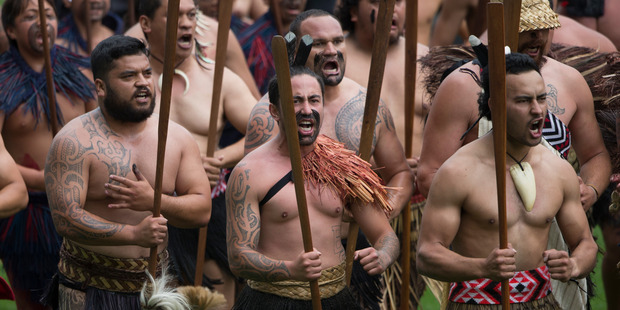 Maori warriors rush across the field as crowds gather at the funeral of Jonah Lomu. Photo / Nick Reed
