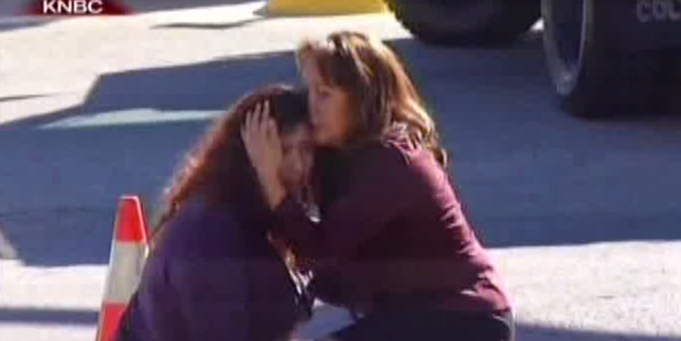 Two women comfort each other after the mass shooting. Police have said that there were deaths but have not said how many. 