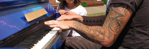 SWEET SOUNDS: Paihia's piano man Craig Michael Gregory tickles the ivories on the town's public piano while young fan Allie Hancox, 6, watches intently. PHOTO/PETER DE GRAAF