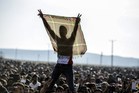 Kurdish people flash the victory sign during a celebration rally near the Turkish-Syrian border after the 'liberation' of Kobane. Photo / AFP Kurdish people flash the victory sign during a celebration rally near the Turkish-Syrian border after the 'liberation' of Kobane. Photo / AFP