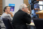 Averil Gardiner shields her face from a TV camera during the trial in the Invercargill District Court yesterday. Beside Gardiner is counsel Simon Claver. Photo / ODT Averil Gardiner shields her face from a TV camera during the trial in the Invercargill District Court yesterday. Beside Gardiner is counsel Simon Claver. Photo / ODT