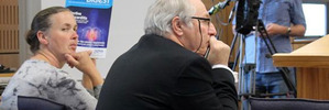 Averil Gardiner shields her face from a TV camera during the trial in the Invercargill District Court yesterday. Beside Gardiner is counsel Simon Claver. Photo / ODT