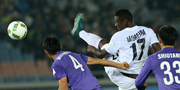 Auckland City FC's Joao Moreira of Portugal plays the ball past Sanfrecce Hiroshima's Hiroki Mizumoto and Tsukasa Shiotani, right. Photo / AP