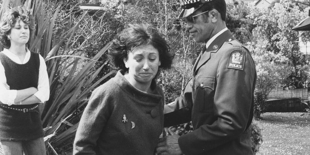 Jane Sabine is led to a police car as her sister Lee, left rear, looks on. 25 September 1984. Photo / Michael Bramley