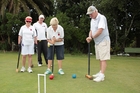 Helen Heppner takes a shot at the Epsom Remuera Croquet Club, as (from left) Maida Beetson, Regan Doherty and Bruce Heasley look on. Photo / Peter Calder Helen Heppner takes a shot at the Epsom Remuera Croquet Club, as (from left) Maida Beetson, Regan Doherty and Bruce Heasley look on. Photo / Peter Calder