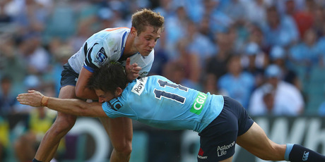 Kyle Godwin of the Force is tackled by Rob Horne of the Waratahs. Photo / Getty Images