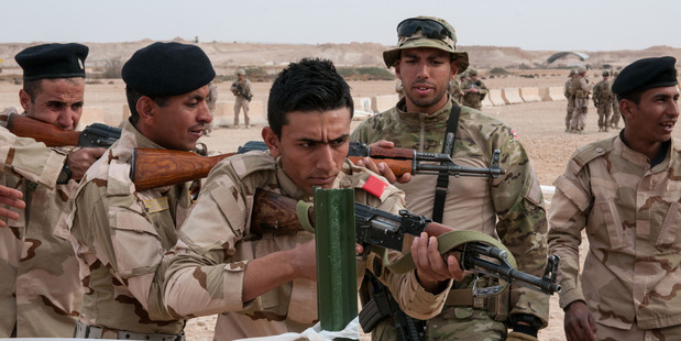 A Danish trainer tells an Iraqi army trainee to correct his weapon's position during a simulated exercise. Photo / US Army