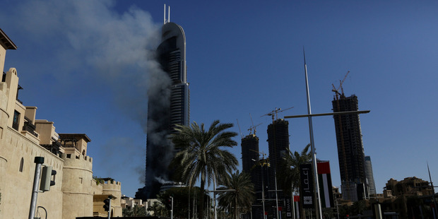 Smoke was still billowing from the Address Downtown on New Year's Day. Photo / AP