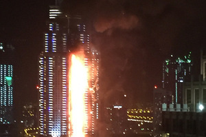 Smoke and flames pour from the Address Downtown hotel tower shortly before the New Year's fireworks display. Photo / Getty Images