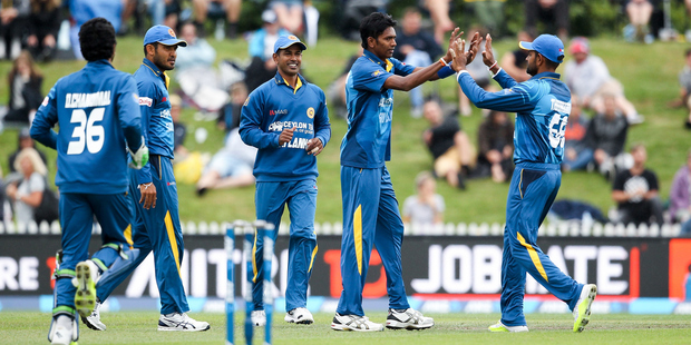 Dushmantha Chameera, second right, celebrates with his Sri Lankan team mates after Kane Williamson is sent packing. Photo / Getty Images