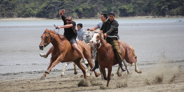 Frontrunners in the Pawarenga Cup - one of many races along the Whangape Harbour shore - charge towards the finish line. PHOTO / PETER DE GRAAF