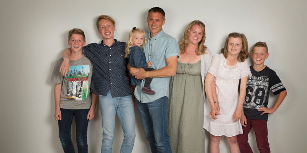 Martin Binnie and his wife Melanie Binnie with their family. They are selling their family home to travel Europe in a motorhome. Photo / Tony Gatman