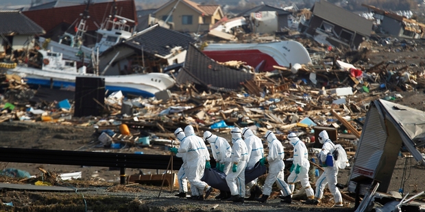 Japanese police recover a body on a search and recovery mission near Fukushima in the aftermatch of the earthquake and tsunami. Photo / AP