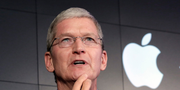 FILE - In this April 30, 2015, file photo, Apple CEO Tim Cook responds to a question during a news conference at IBM Watson headquarters, in New York. Cook said his company will resist a federal magis