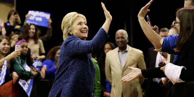 Hillary Clinton high-fives an audience member. Photo / AP