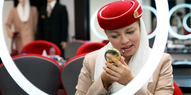 An aircrew student with Emirates Airline applies lip liner during a make-up training session. Photo / Getty Images