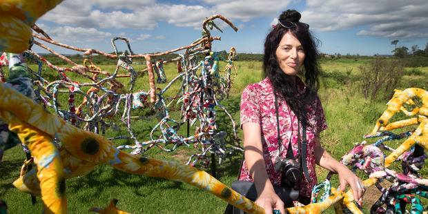 Artist Audrey Boyle stands amongst her sculpture, "flowerpower" on Thursday. Photo / Nick Reed
