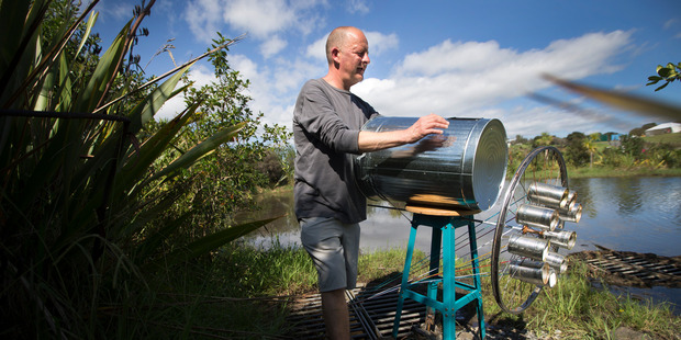 Artist Simon Gray installs his sculpture called "you say hola, I say Hello". Photo / Nick Reed