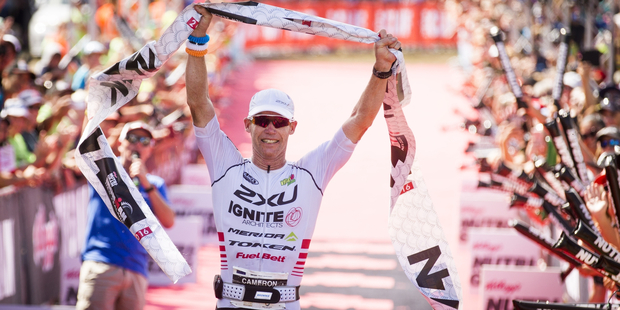 Cameron Brown crosses the finish line to win his 12th Ironman New Zealand. Photo / John Cowpland