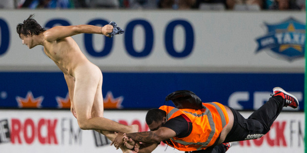 A streaker invades the field at the Super Rugby opener between the Blues and Highlanders at Eden Park last Friday. Photo / Jason Oxenham
