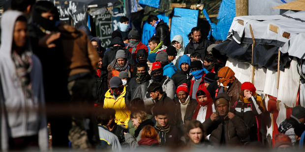 Migrants and activists face-off with French riot police. Photo / AP