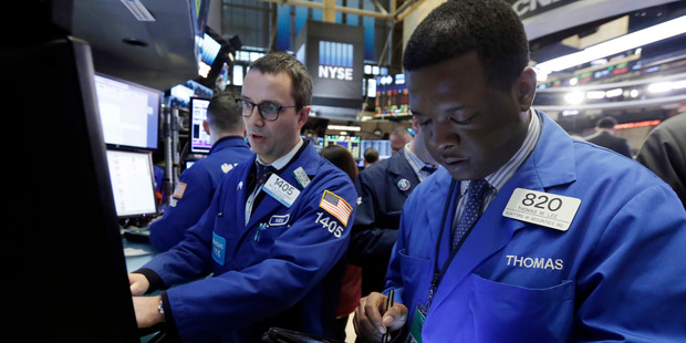 Specialist Neil Gallagher, left, and trader Thomas Lee work on the floor of the New York Stock Exchange. Photo / AP