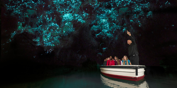 Visitors to the Waitomo Caves take in the spectacular glow-worm show.