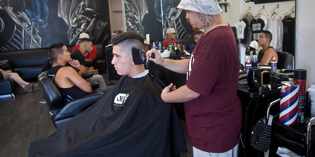 Mike Perring of Faded Barber Shop gives client Wisdom Toki an undercut. Photo/Andrew Warner