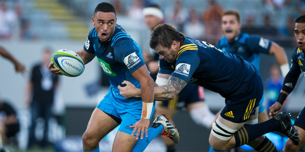 Blues halfback Bryn Hall bursts away from Highlanders no.8 Liam Squire in the opening match of Super Rugby season between the Blues and the Highlanders at Eden Park.