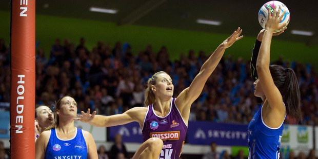 Northern Mystics Maria Tutaia on the attack against Queensland Firebirds player Laura Geitz. Photo / Nick Reed