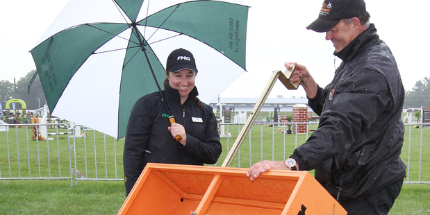 DOODY DUTY: Jeff Young, right, shows his SuperScooper to Jenny Tukiwaho Stokes, of Hamilton, at the Hawke's Bay Showgrounds yesterday. PHOTO/Duncan Brown