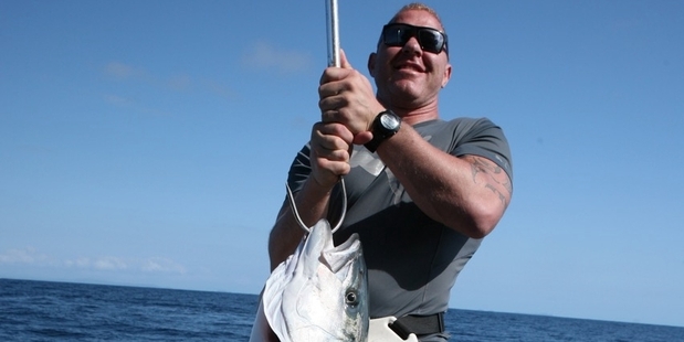 Shane Cameron is happy with his first kingfish. Picture / Geoff Thomas