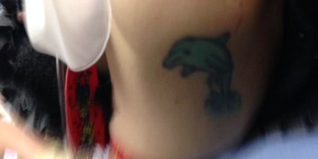 The distinctive dolphin tattoo which police hope will identify the mystery woman. Photo / Supplied