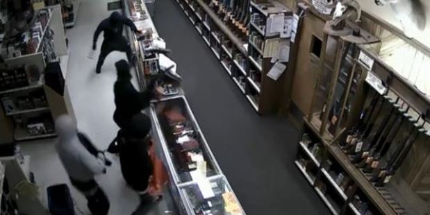 The hooded thieves smashed a row of glass cases with hammers and seized handguns. Photo / Crime Stop Houston