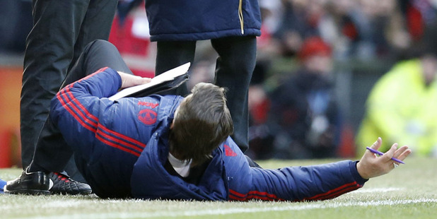 Manchester United manager Louis van Gaal, on the ground as he complains to the officials. Photo / AP
