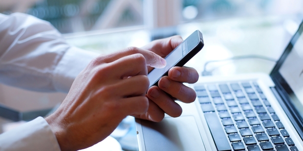 People aged 18 to 29 were more likely to check sites like Facebook, Twitter or Instagram at work. Photo / Getty Images
