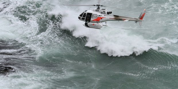 The police national dive team uses an underwater camera suspended from a helicopter to look underwater in a dangerous bay near Curio Bay for Mike Zhao-Beckenridge